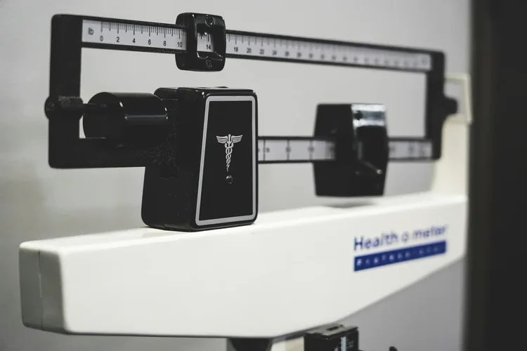 A close-up of a medical balance-beam scale