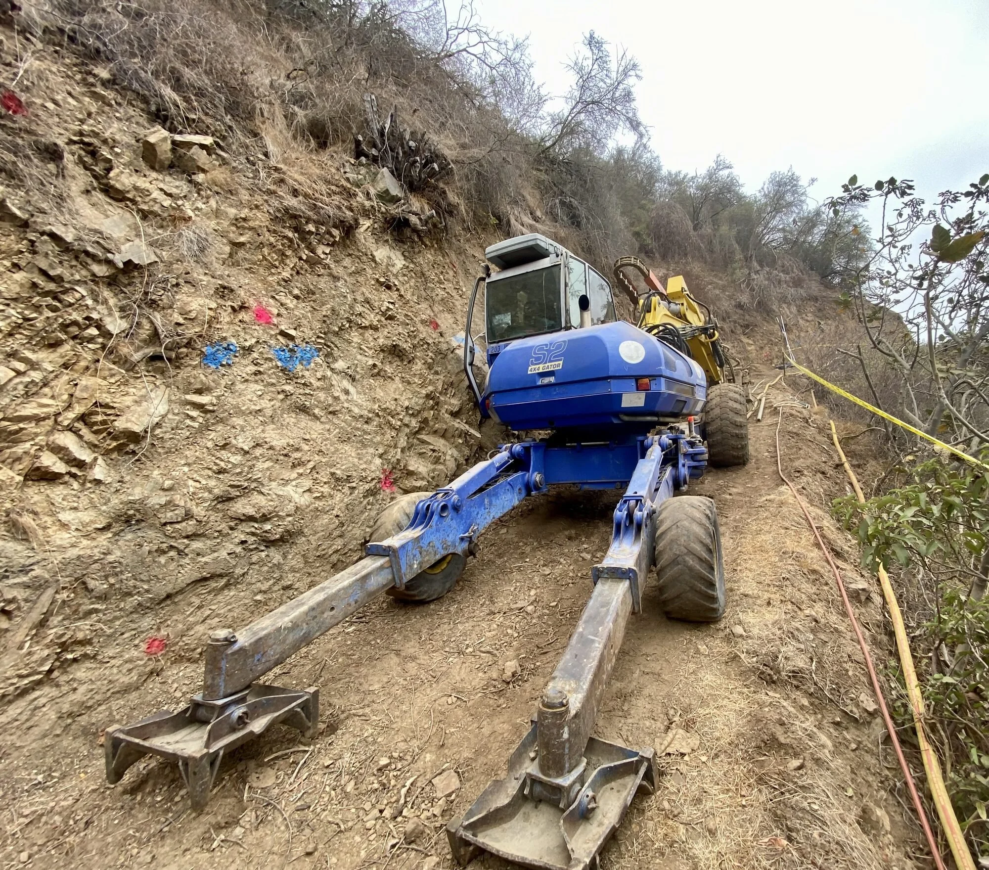 Spider lift excavator on a steep hillside slope
