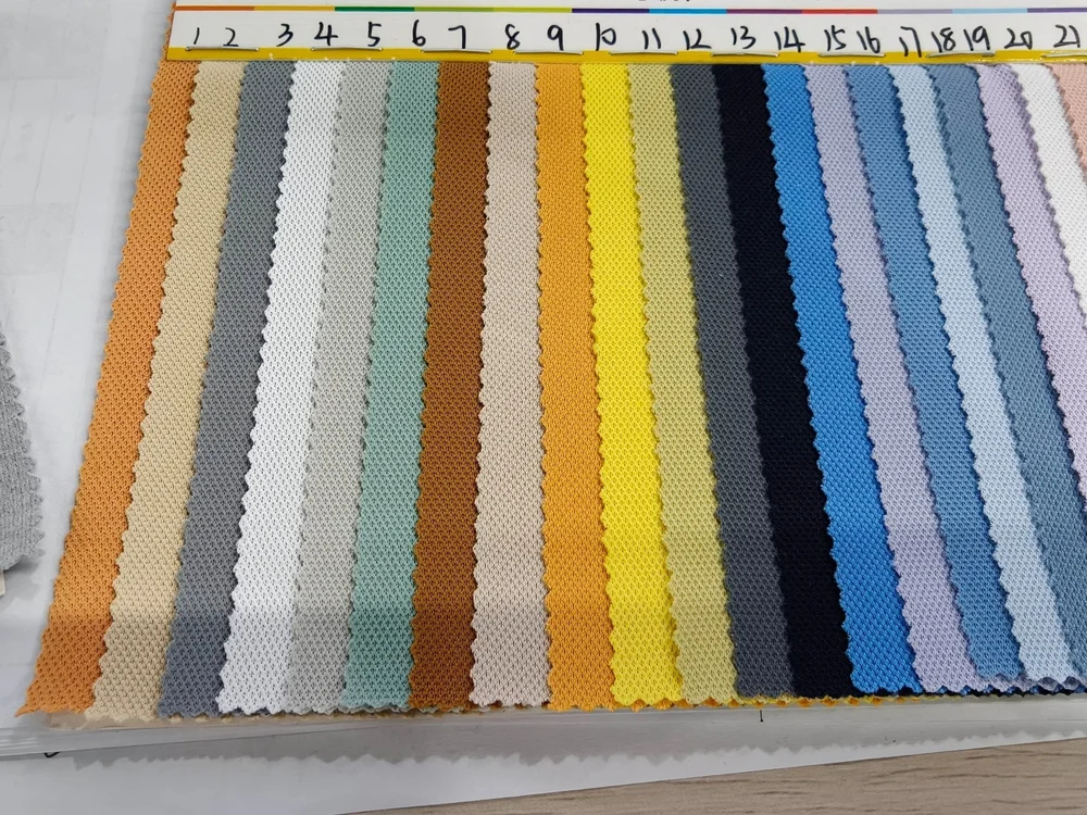 Textured fabric swatches arranged in a range of colors