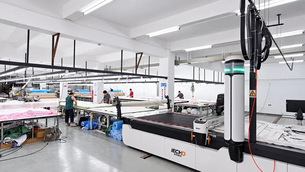 Fabric-cutting equipment and worktables on the factory production floor