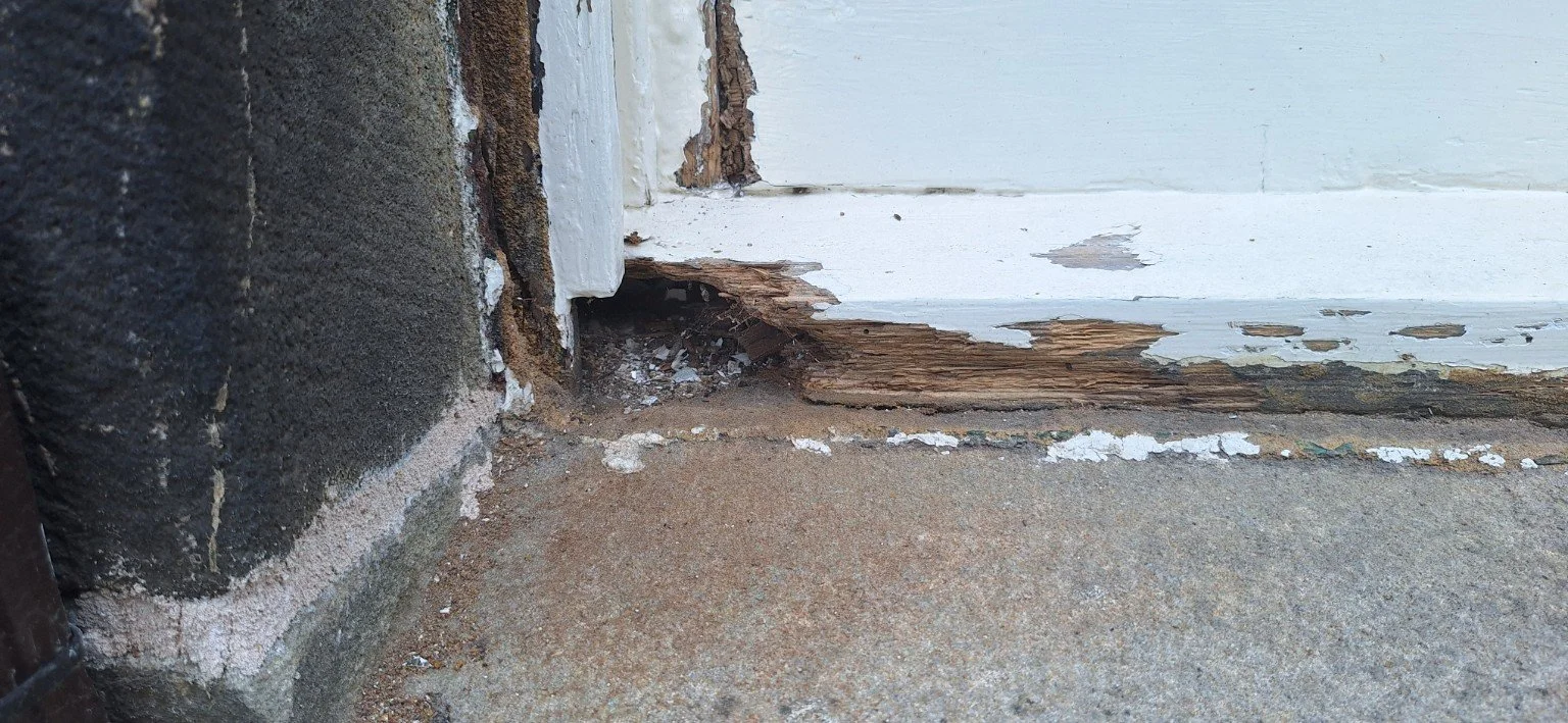 Deterioration along the lower section of a timber window before work