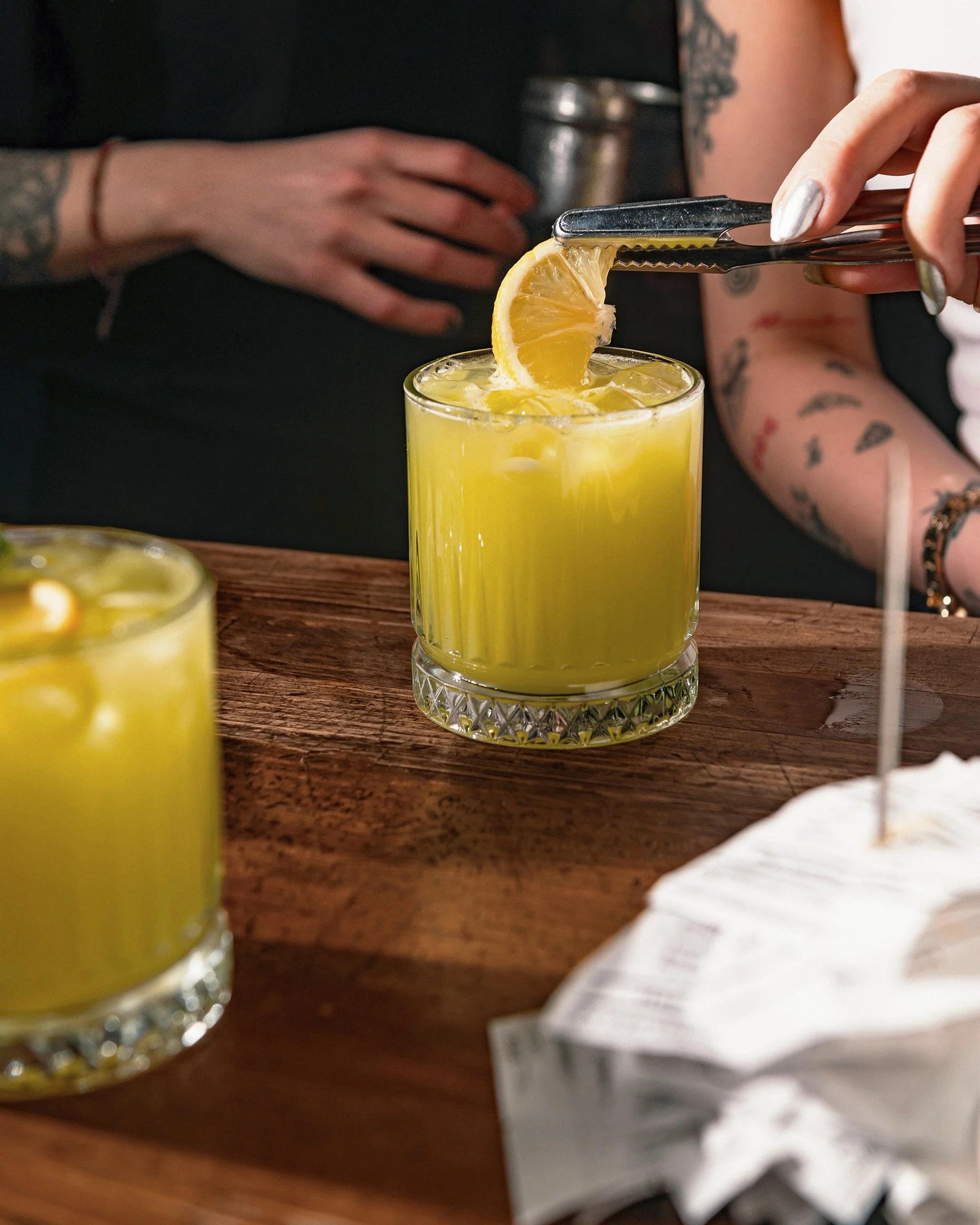 Adding citrus garnish to a cocktail
