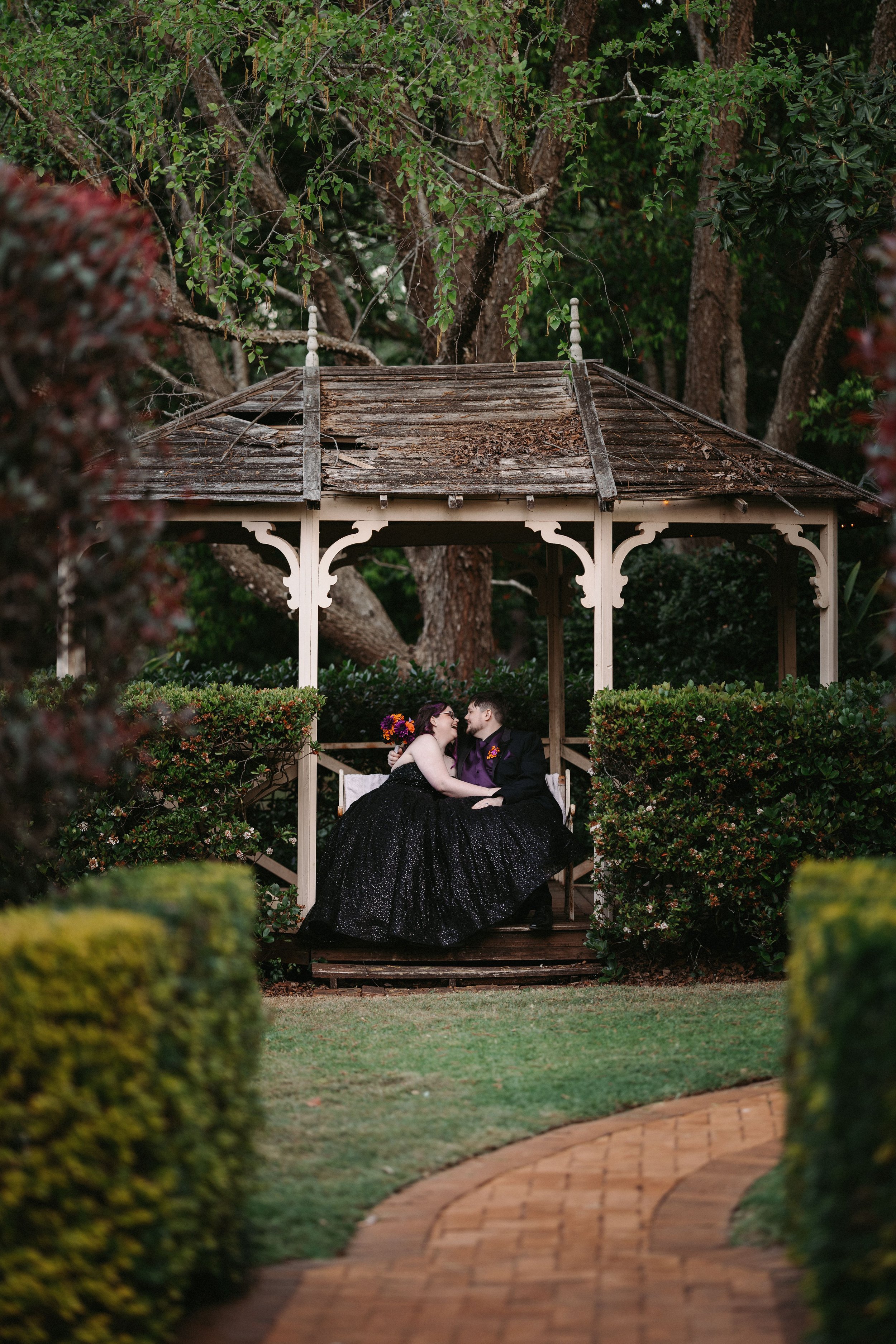 Chantel and Baylee sharing a quiet moment in the garden gazebo at Shambala Estate.