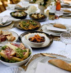 Shared wedding dishes arranged on a reception table.