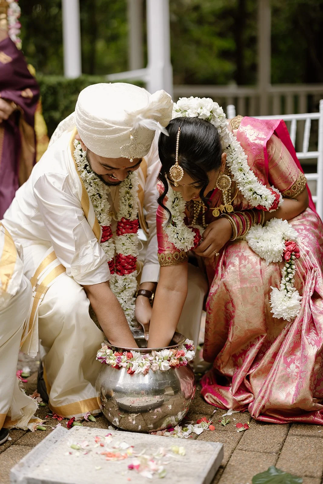Amrita and Arun share a traditional wedding ritual at Shambala Estate.