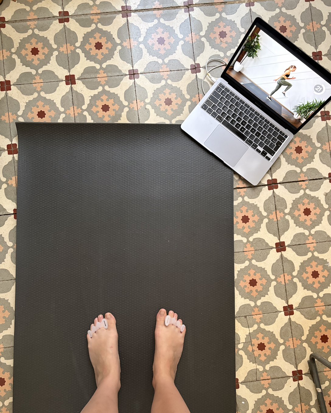 toe spreaders and foot mobility exercises on a yoga mat