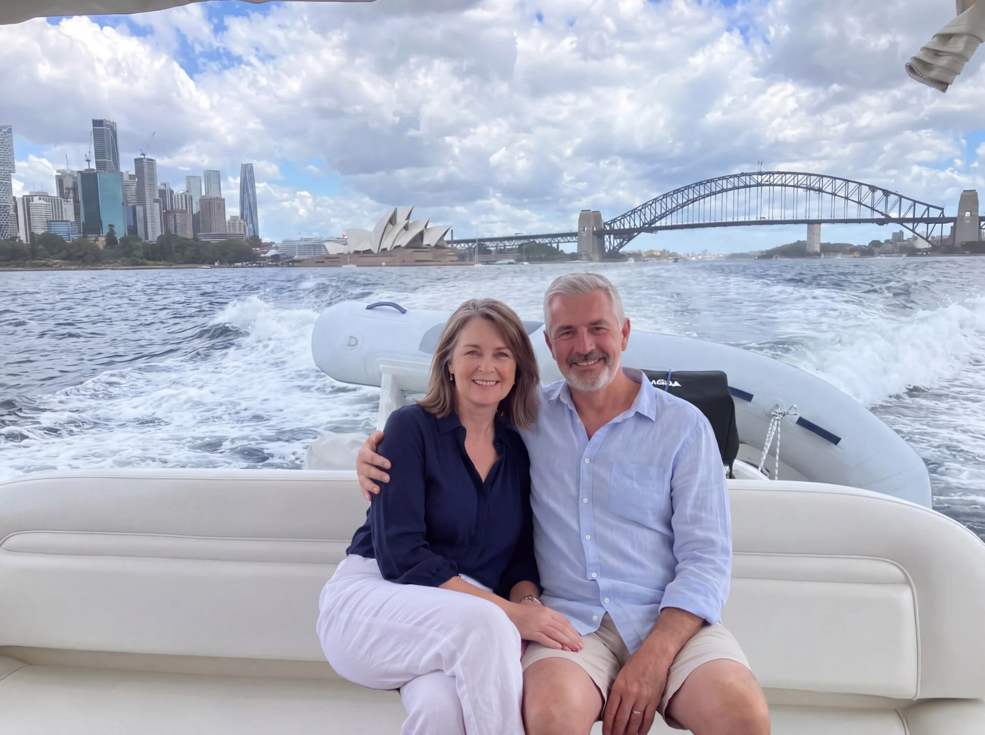 Couple cruising with the Sydney Harbour Bridge behind them