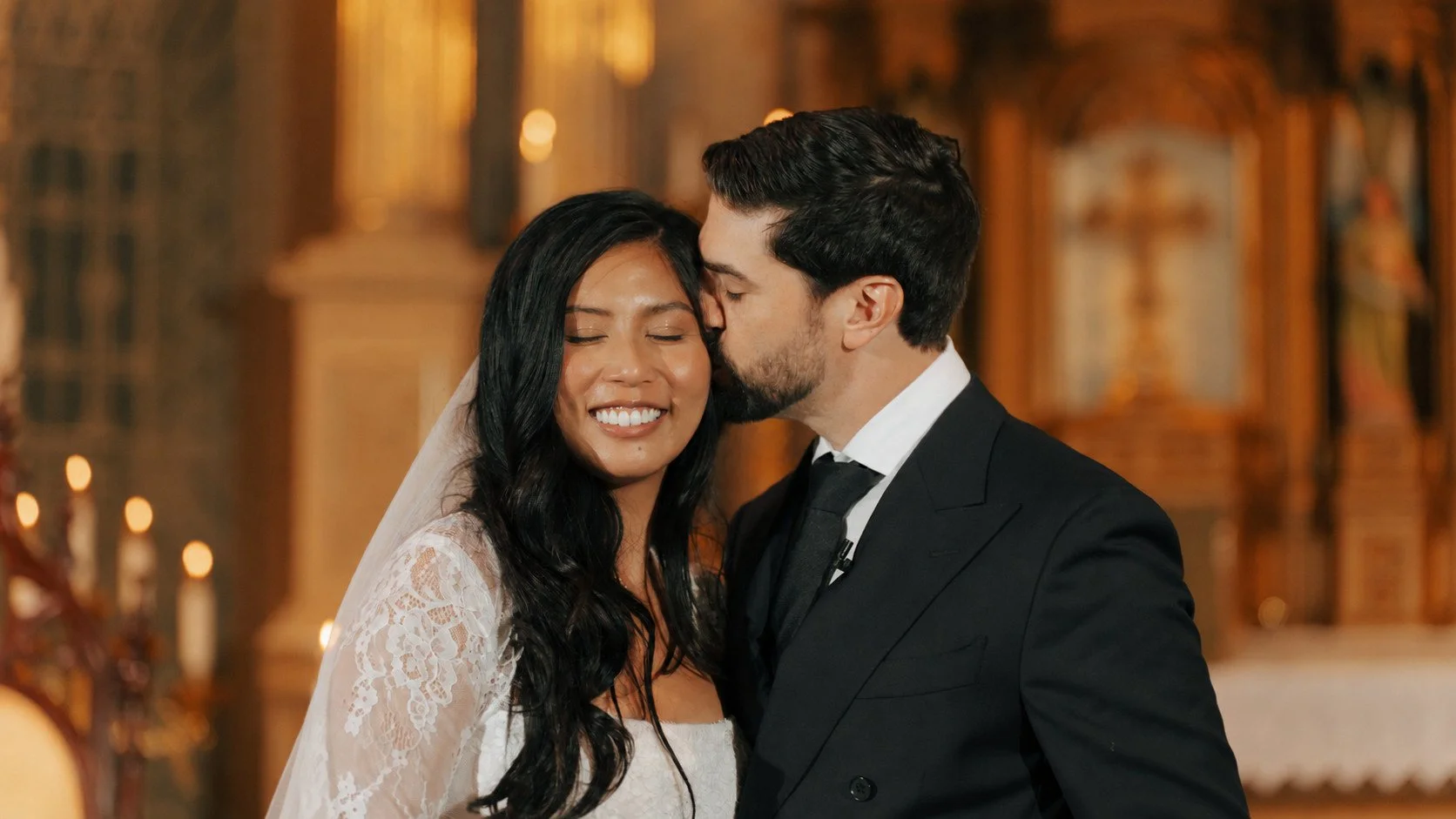 Newlyweds sharing a forehead kiss