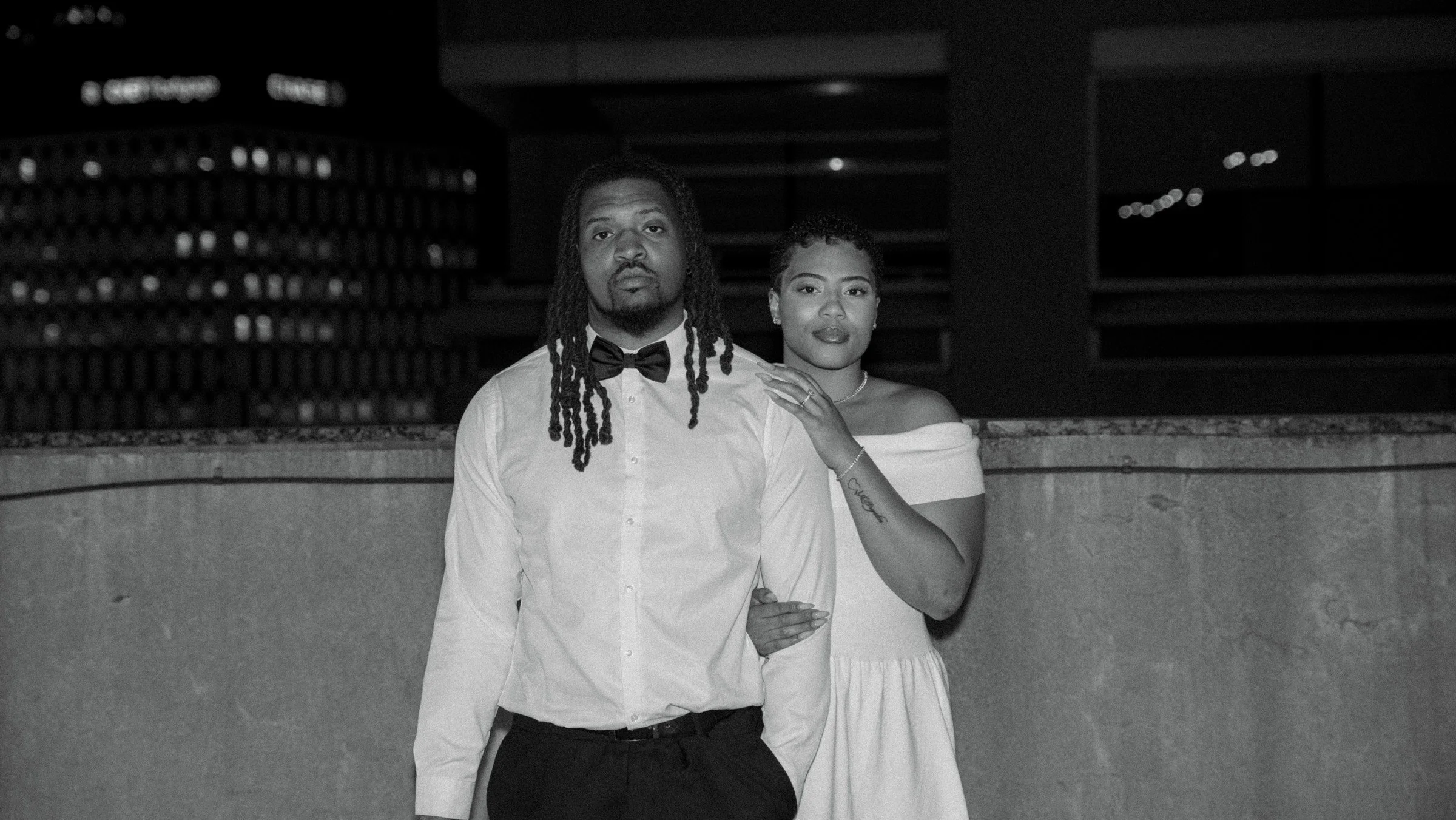 A bride and groom together on a city rooftop, photographed in black and white by Durant Wedding Co.