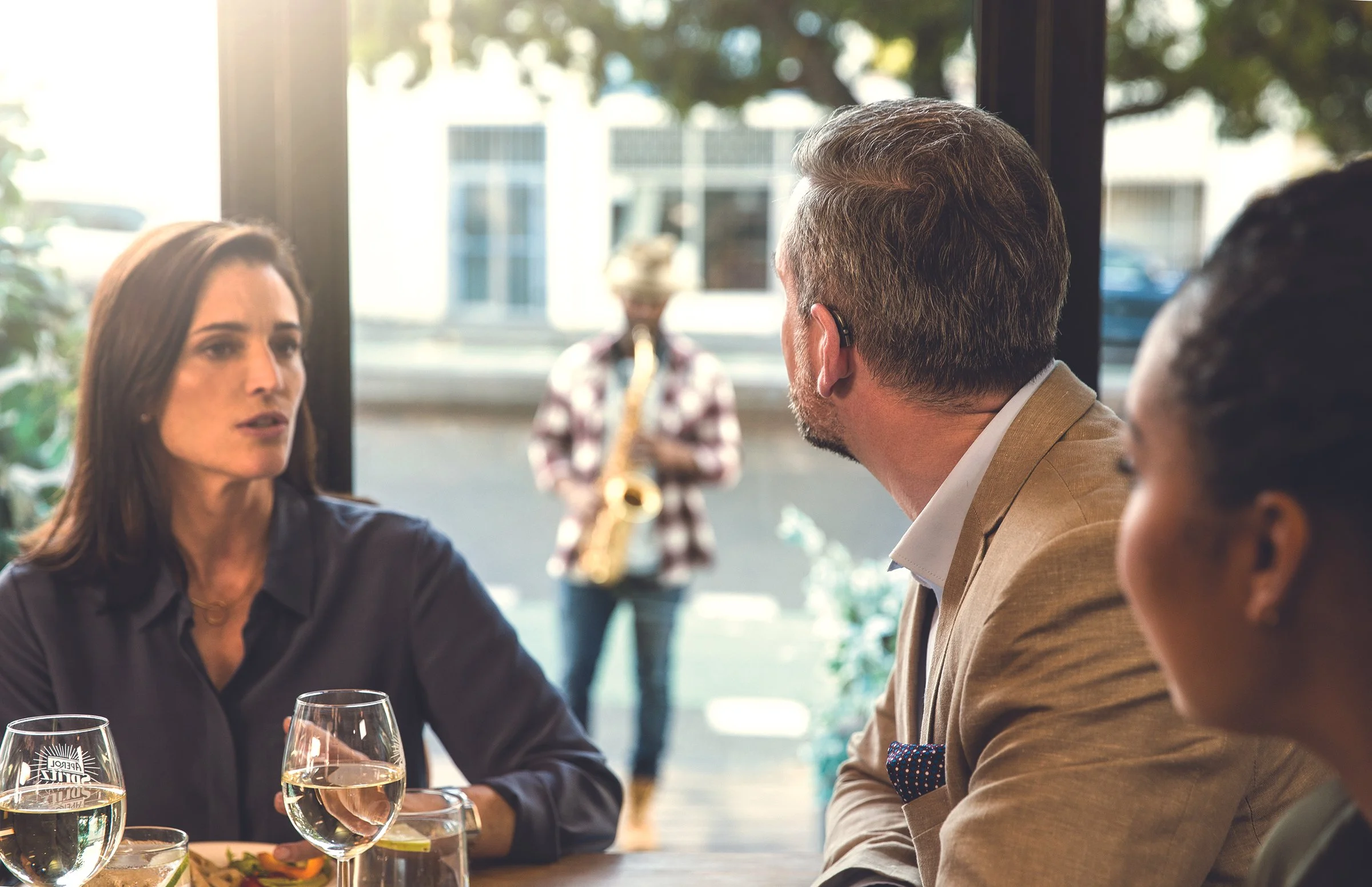 Patient wearing hearing aids in a restaurant setting