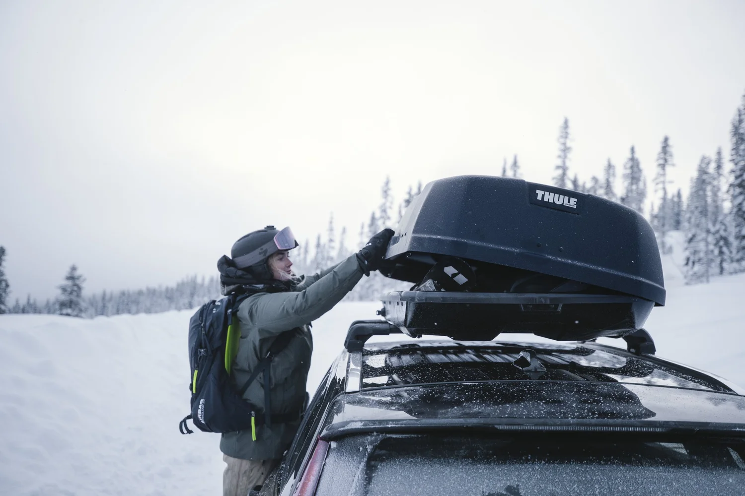 Thule Force XT cargo box on a roof rack in the snow
