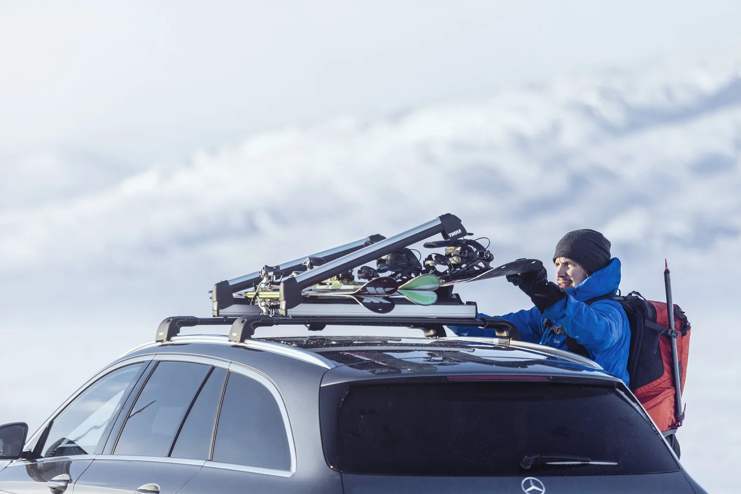 Thule roof rack with a SnowPack ski carrier in the snow