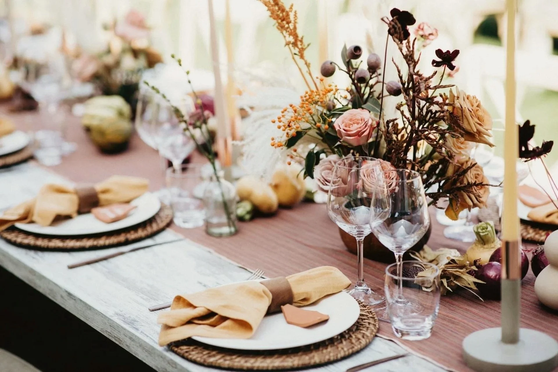 Elegant wedding tablescape with blush florals, glassware, and candlelight — effortless, modern romantic styling by The Wedded Company.