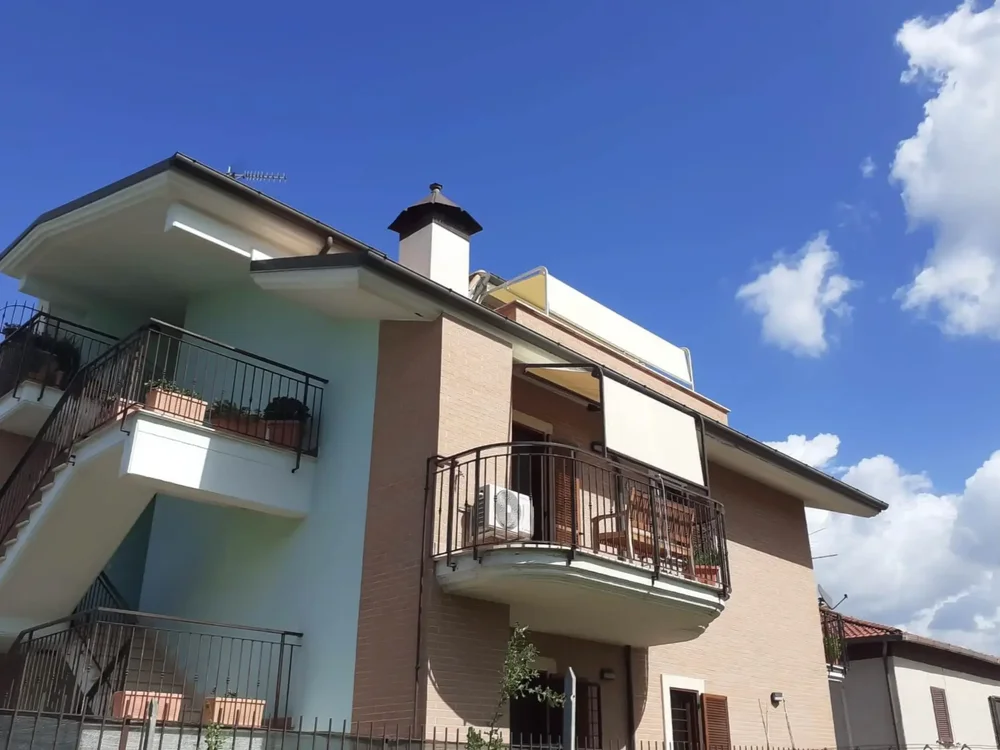 Villa con installazione di tende a capanno Tempotest gialle su misura per balcone e terrazza.