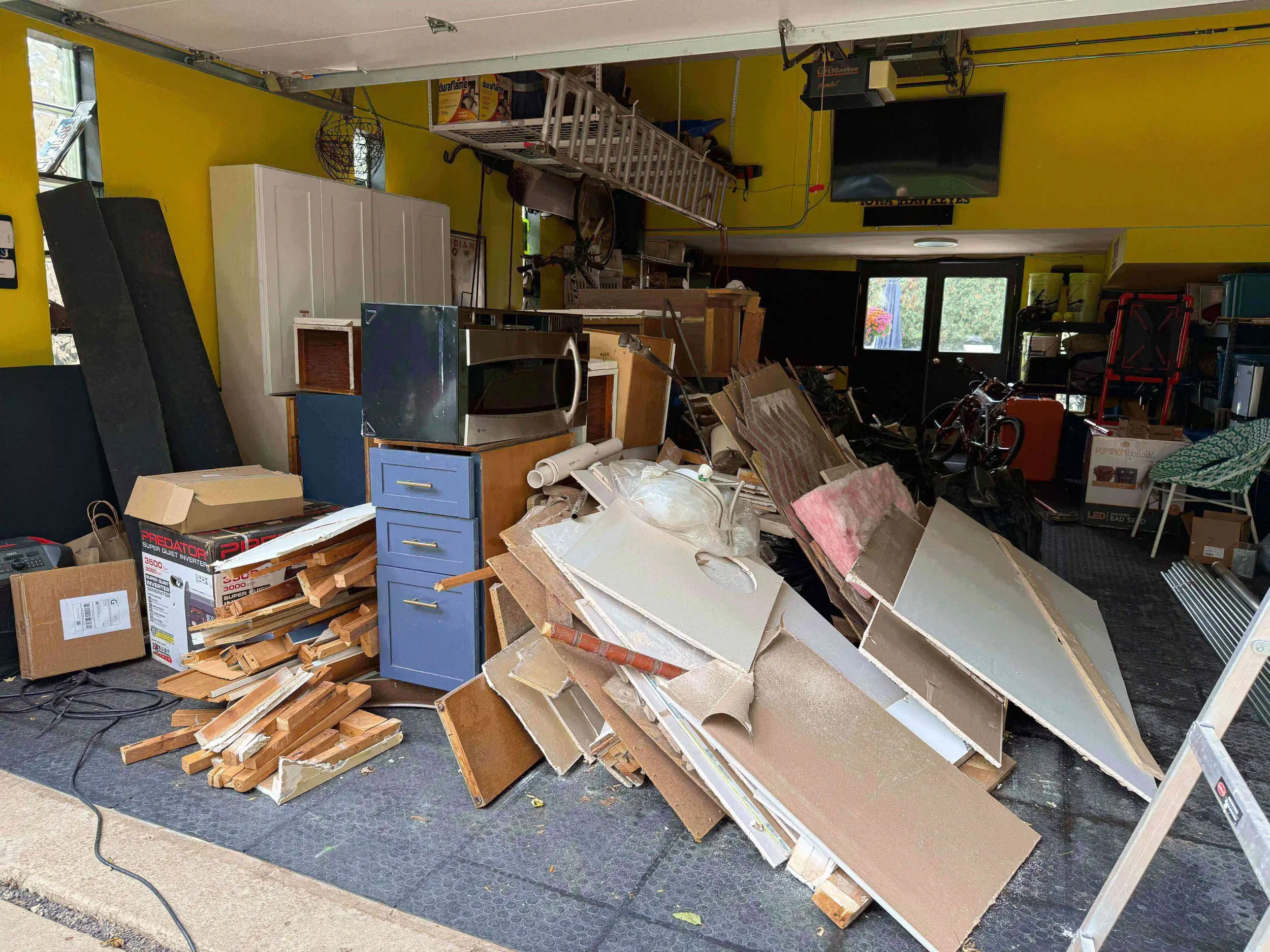 Cluttered garage full of boxes and debris in Skokie, IL before clean-out.