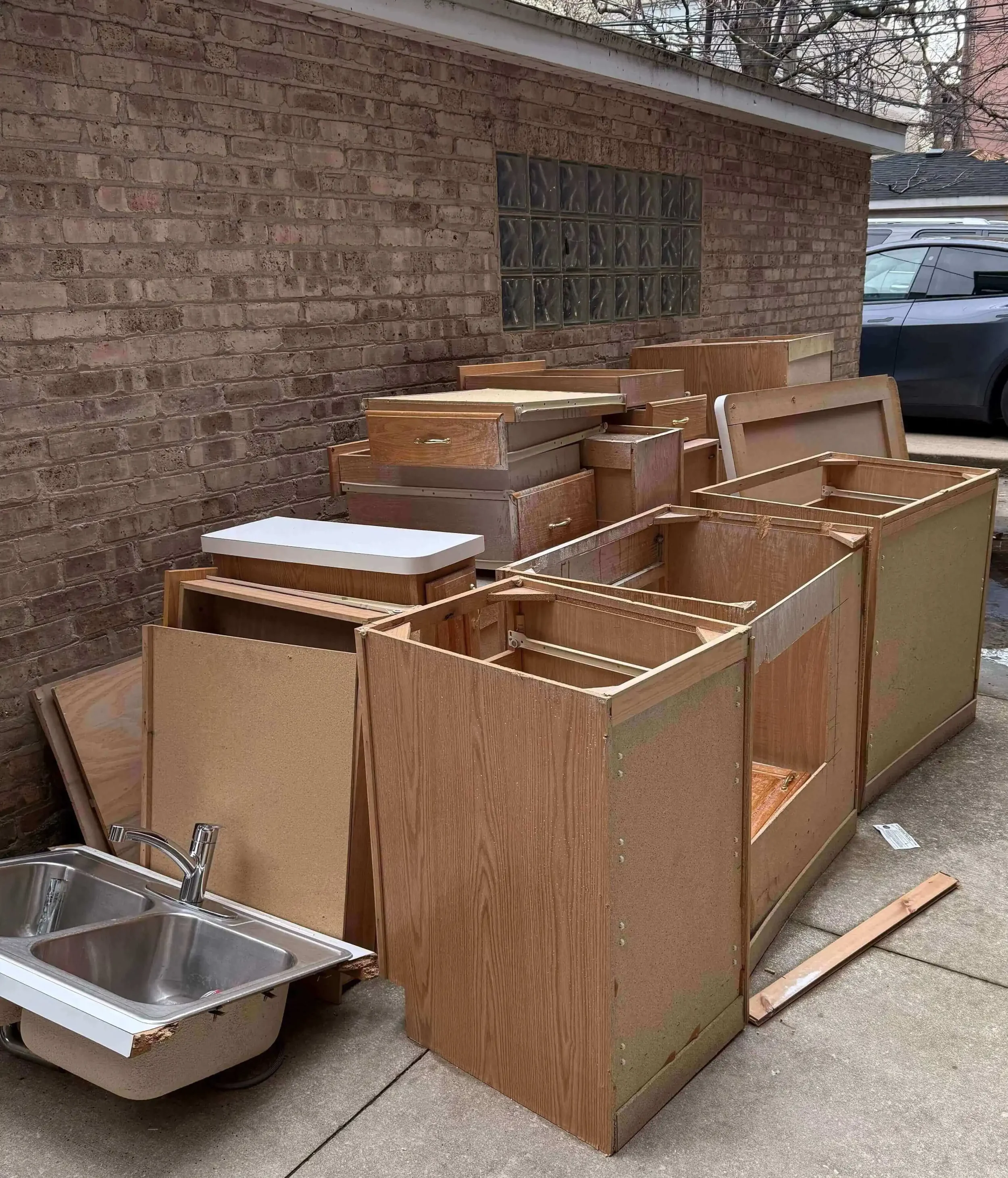 Old kitchen cabinets and heavy sink debris in Chicago, IL before disposal.