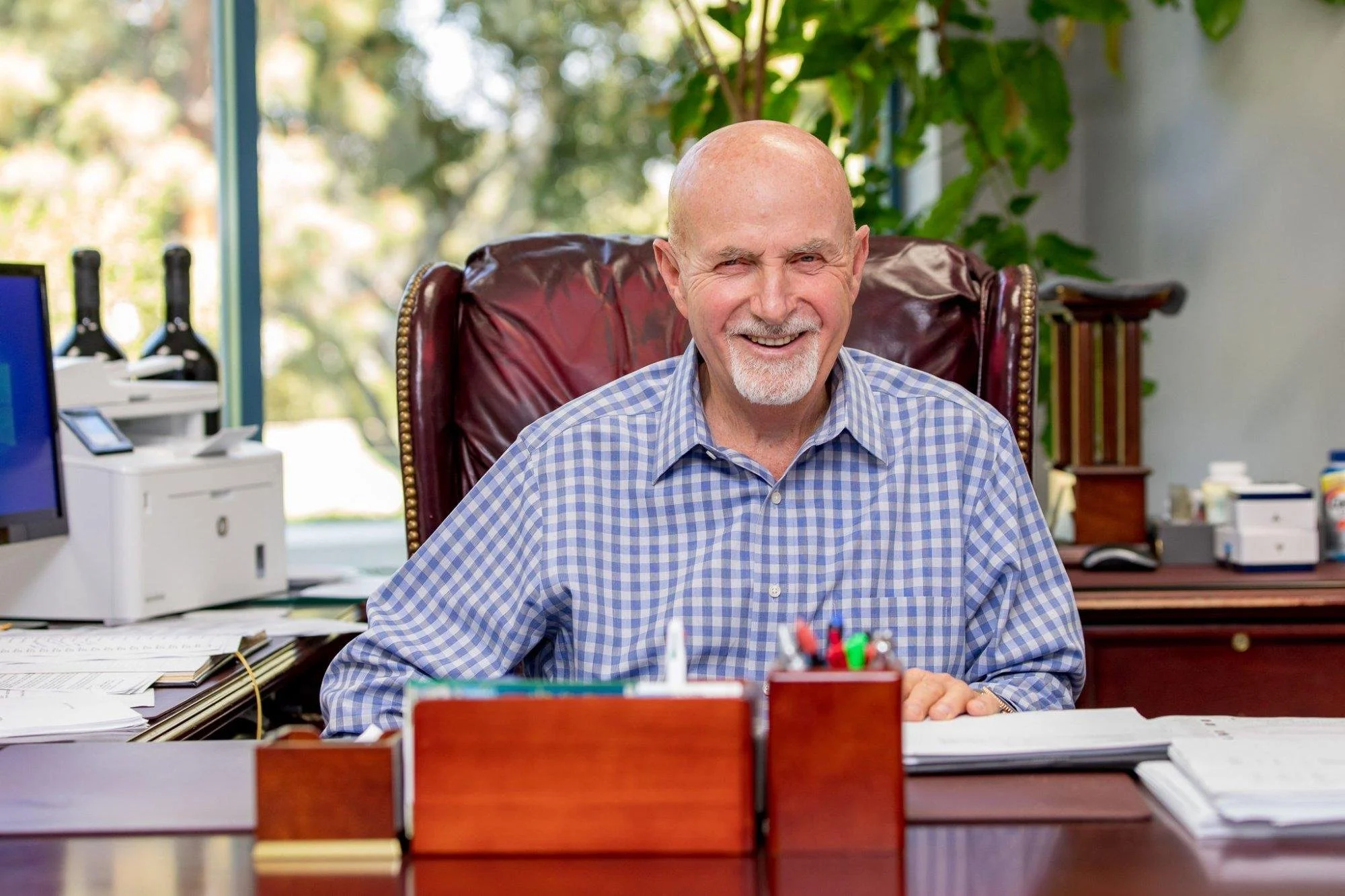 Gill Barnett still at the helm — Gill at his desk, PCI Headquarters, Irvine, CA