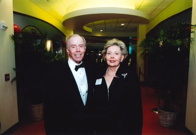 Monroe and his wife at a formal event — a life of business, integrity, and service to others