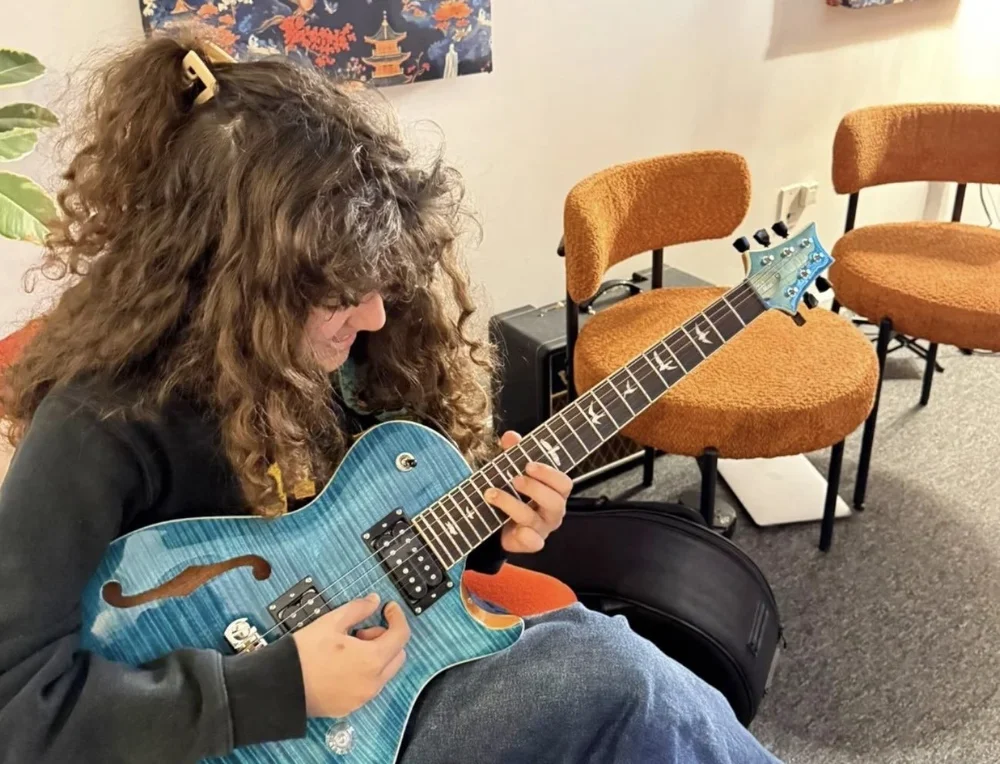 A young guitar student playing an electric guitar in a lesson at Lost Note Guitar Academy in Mar Vista, Los Angeles