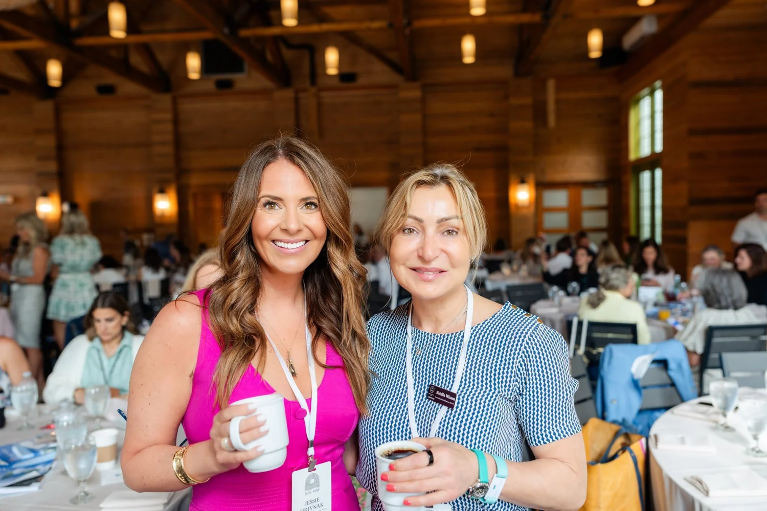 Jessie Hrivnak with a fellow agent at a Compass event