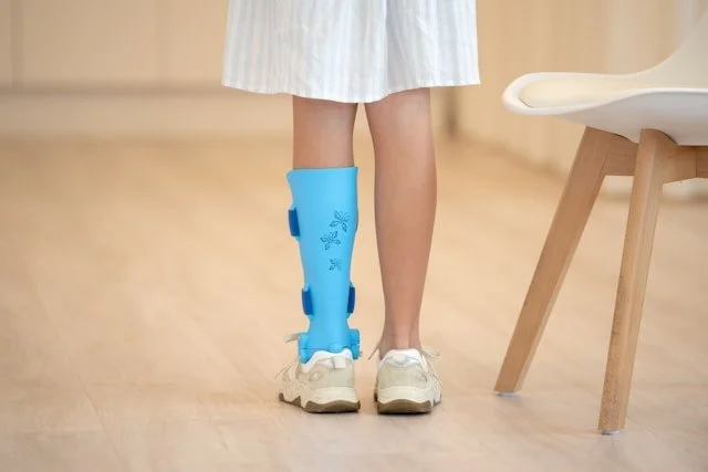 Young girl with leg disability standing confidently showing her leg brace