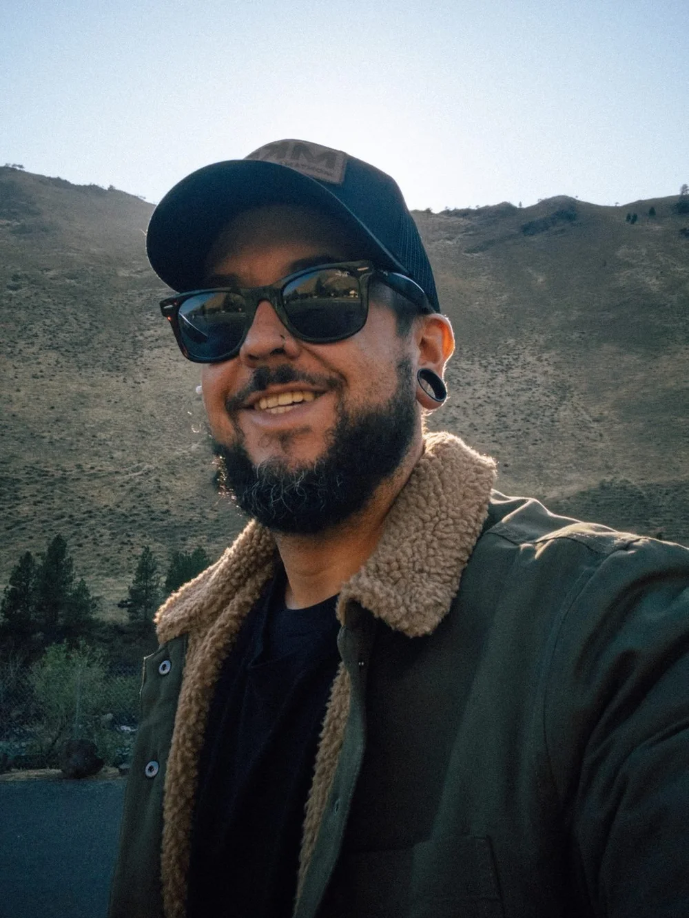 Galen smiling in a sherpa jacket in a canyon