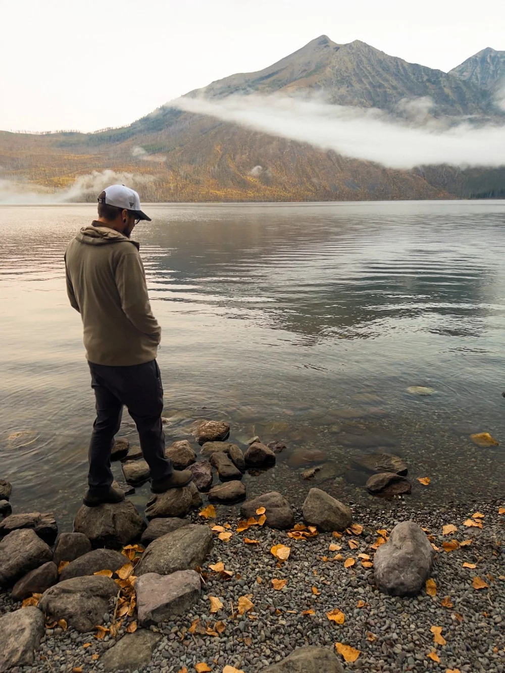 Galen looking out over a misty mountain lake