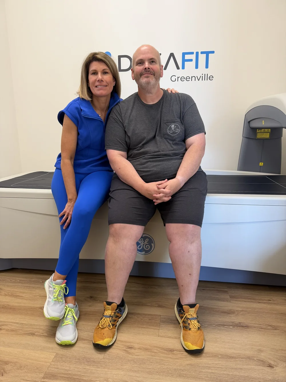 Nicole Weber with a client sitting on the DEXA scanner