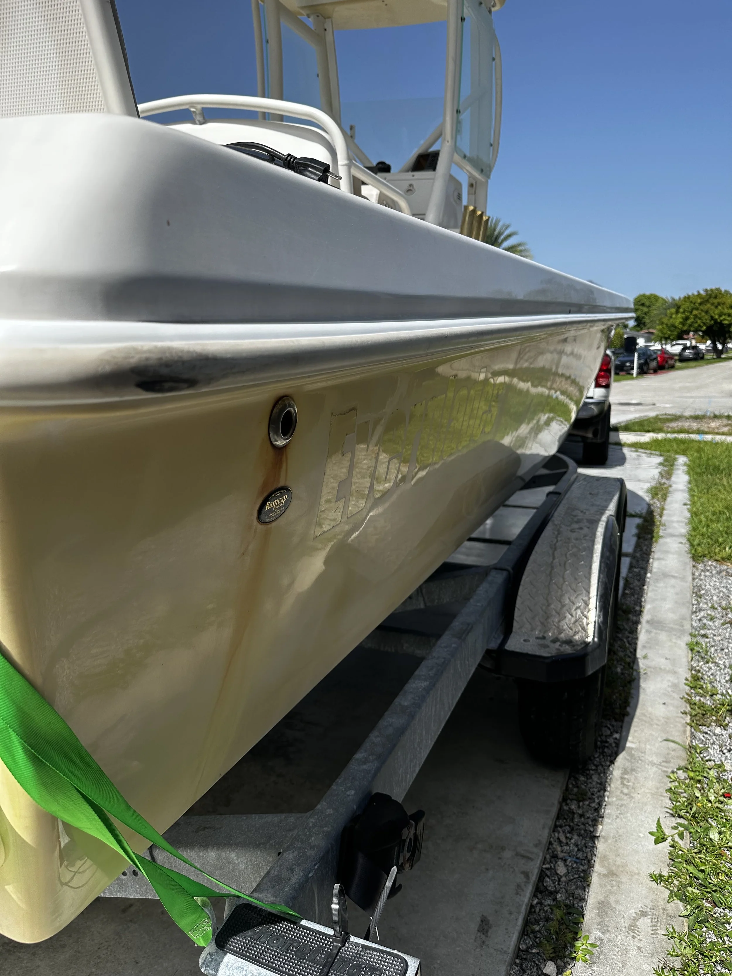 Before boat detailing showing oxidation, staining, and dull gelcoat