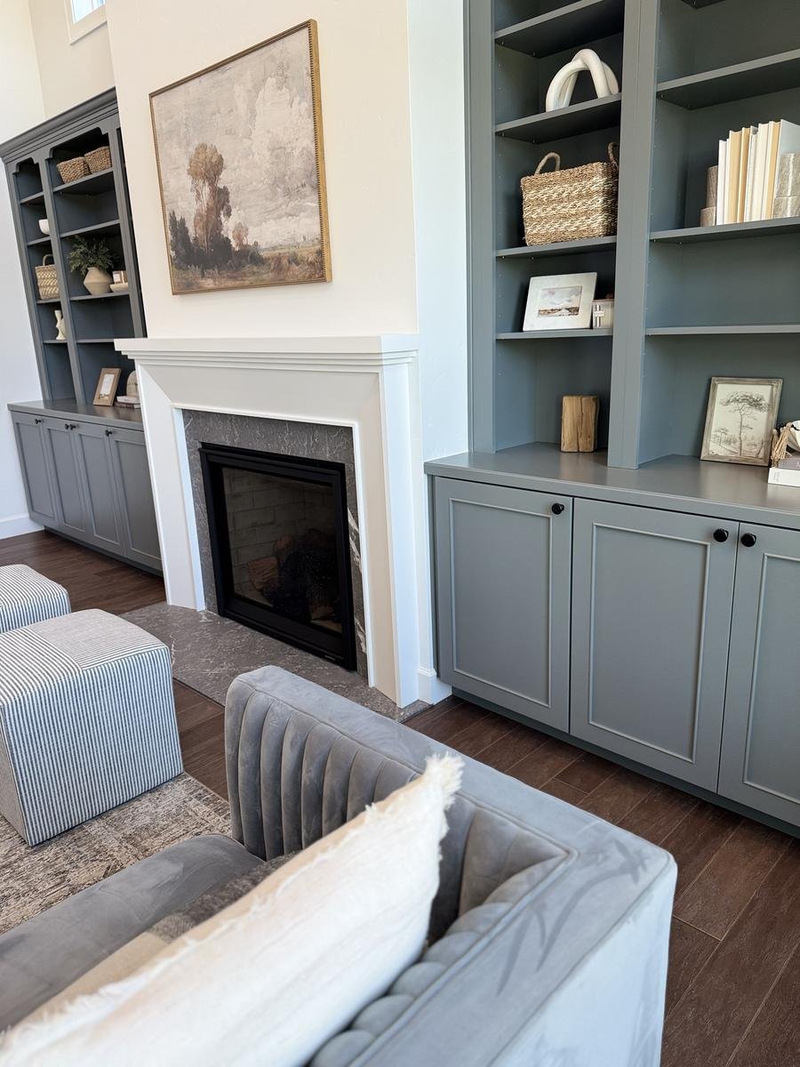 Painted built-in shelves beside a fireplace in a custom home