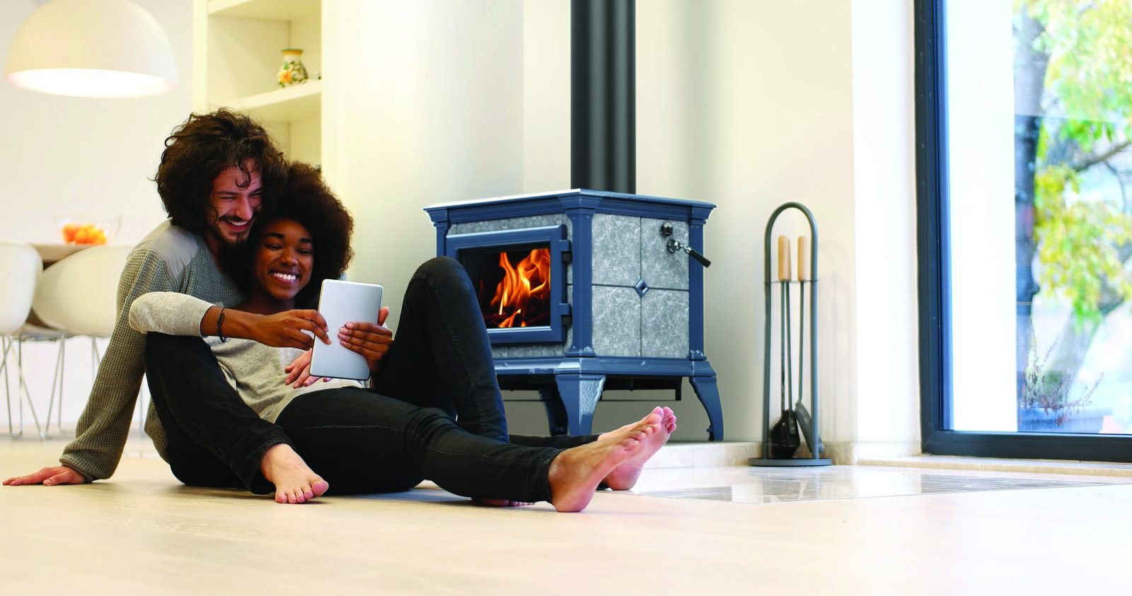A family relaxing beside a burning HearthStone soapstone stove