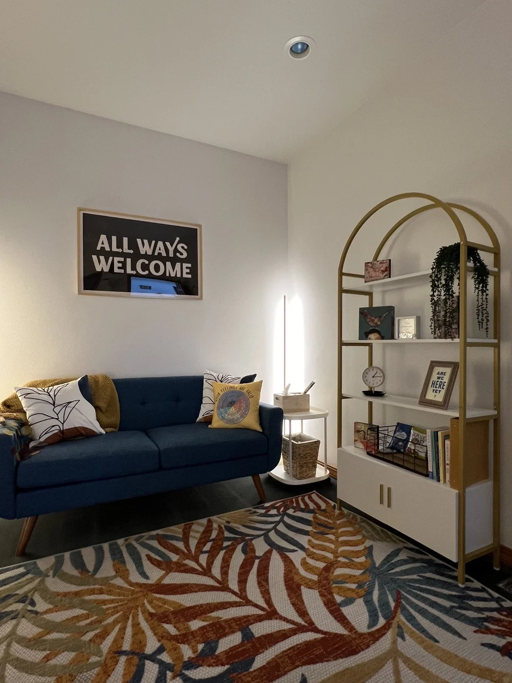 Cheyenne's counseling office in Missoula, with a blue couch and an All Ways Welcome sign