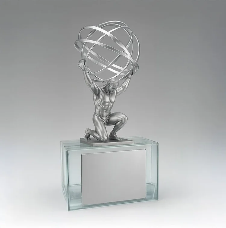 Metal Atlas sculpture supporting an open globe above a clear base