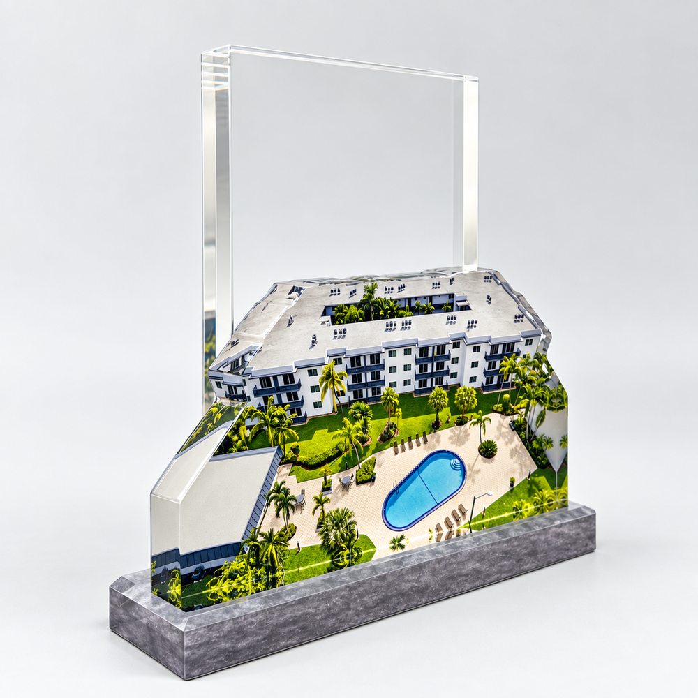 Architectural miniature with a clear panel and a stone-patterned base