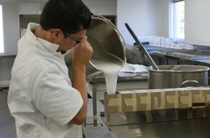 Worker inspecting molds in a Lucite casting room
