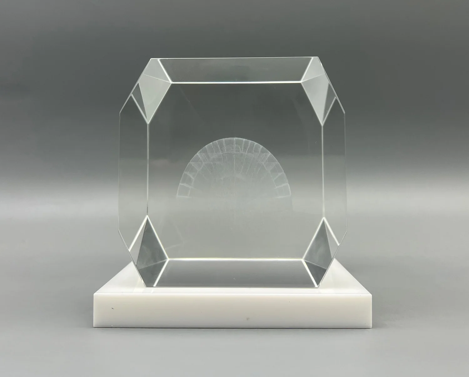 Bevelled crystal cube with an internally 3D laser-etched igloo on a white base