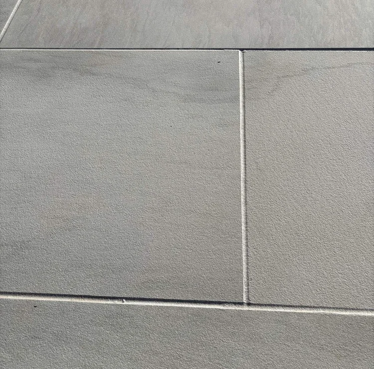 Close view of sealed joints between light-colored exterior panels.