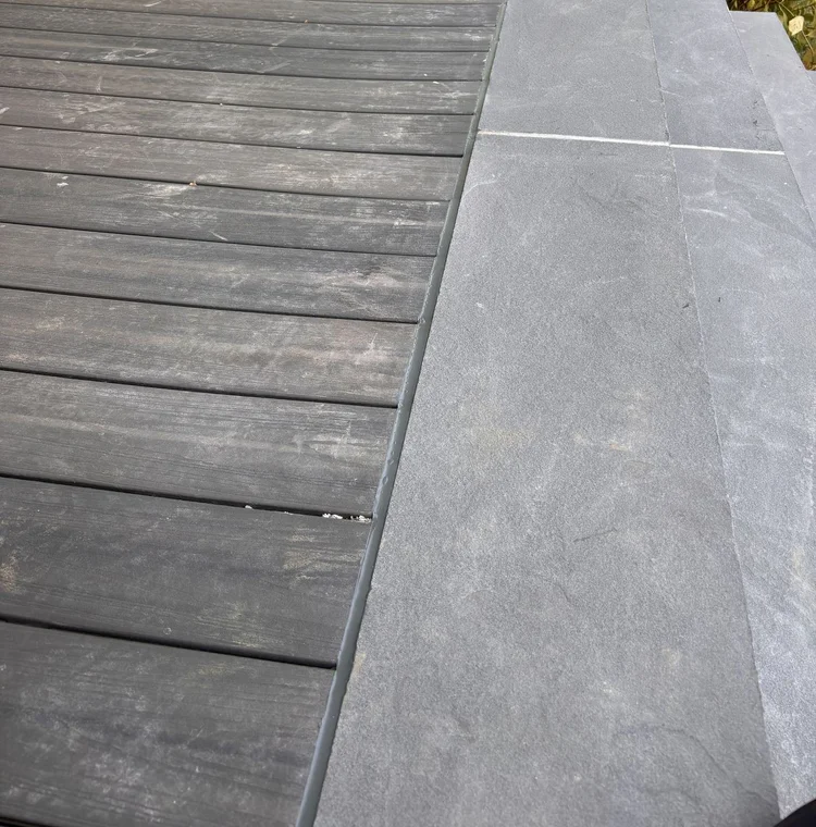 Gray sealant along the deck-to-stone transition.