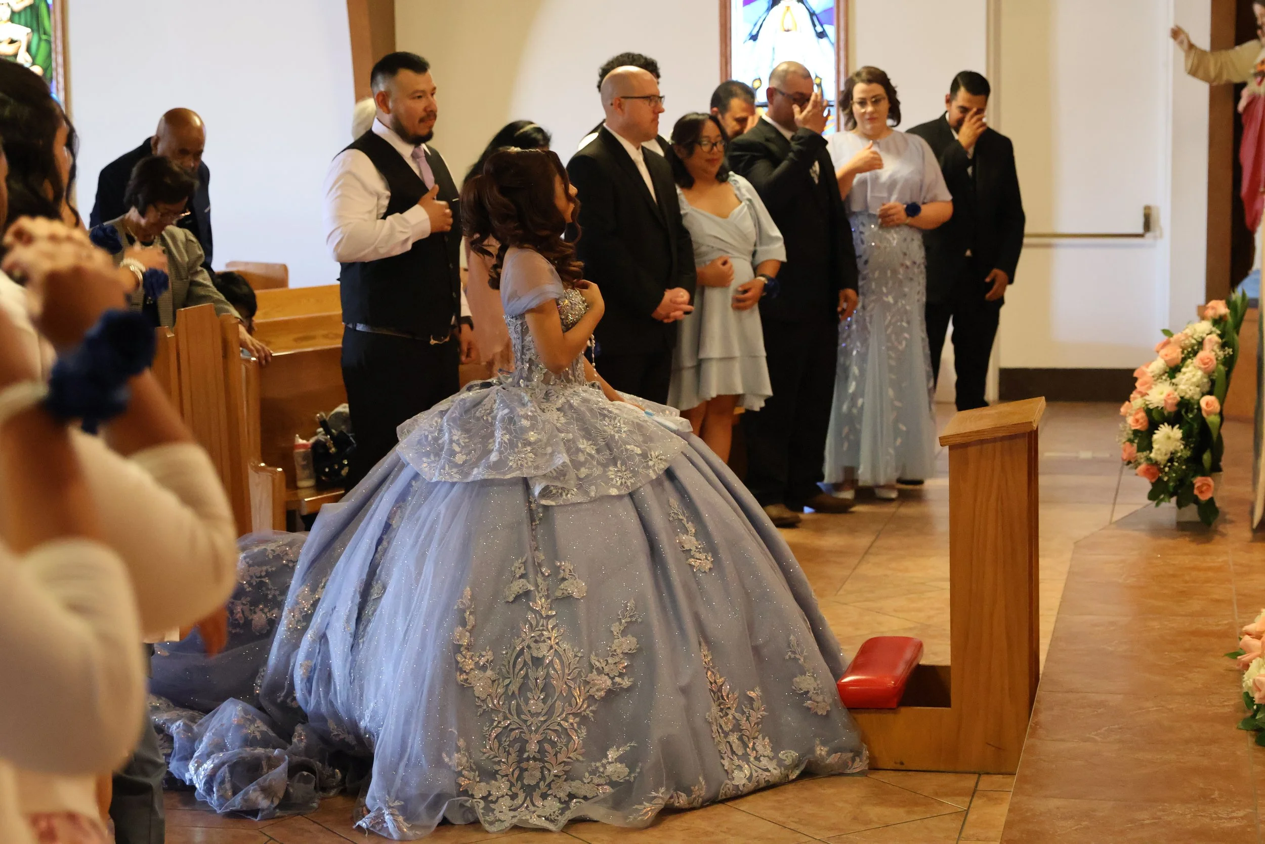 Quinceañera walking down the aisle during a church ceremony