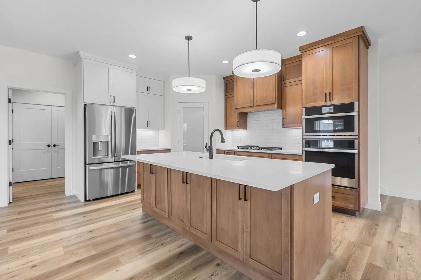Irene Court kitchen with warm wood cabinetry, a generous island and natural light