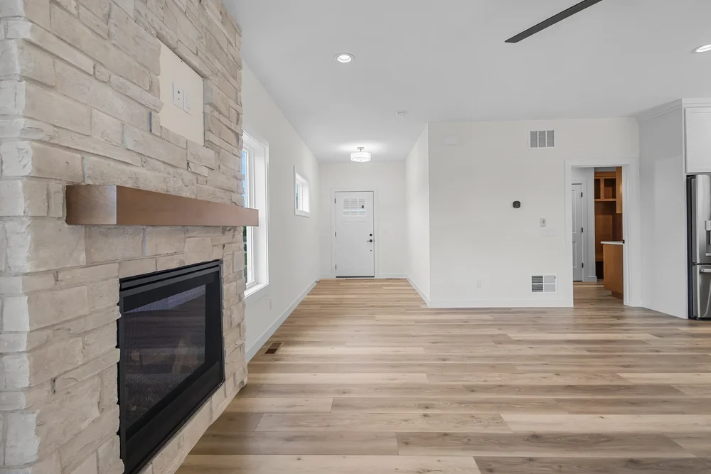 Irene Court — Great room with floor-to-ceiling stone fireplace