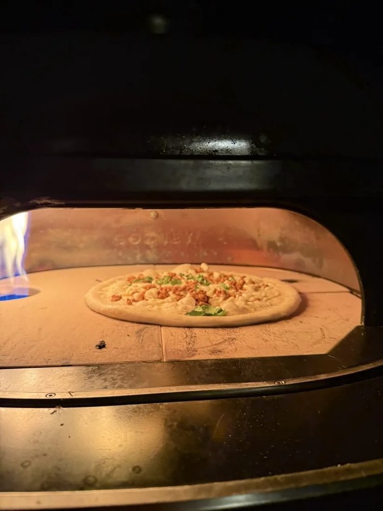 Live-fire pizza oven at an event