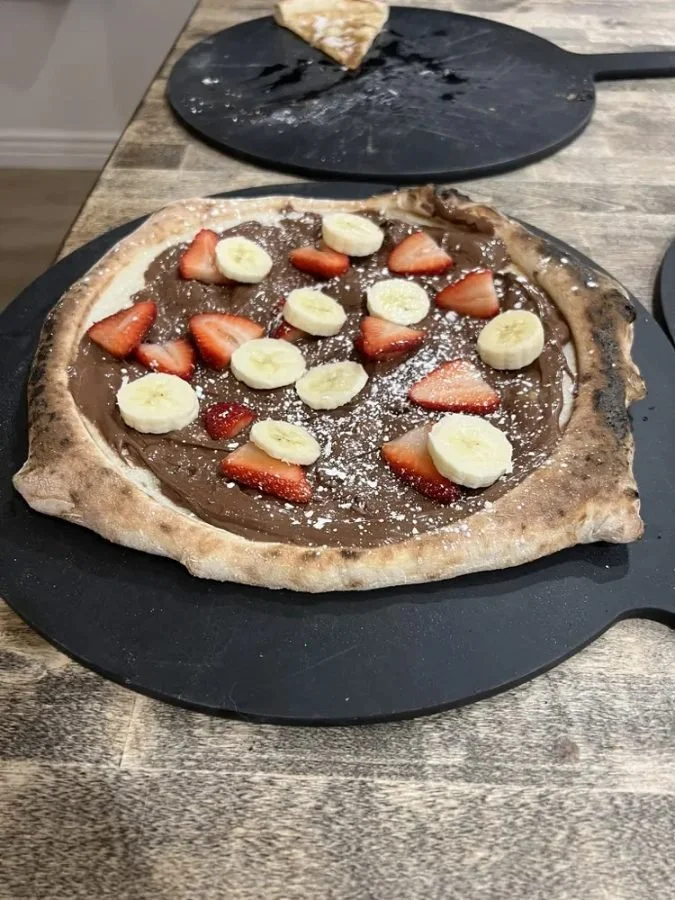 Dessert pizza with chocolate hazelnut spread, strawberries and banana