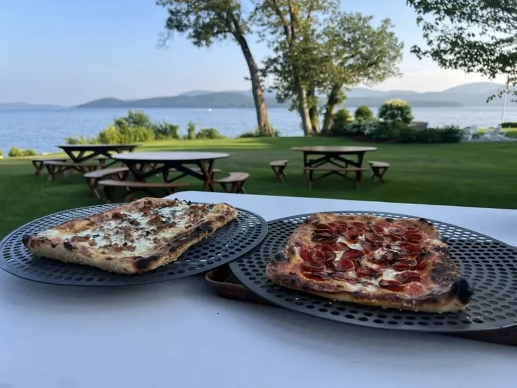 Pizzas on a lakeside picnic table