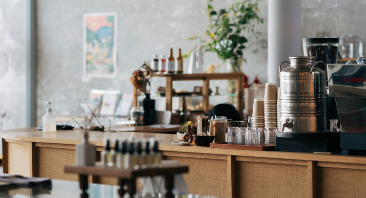 Warm wood and morning light at a coffee counter.