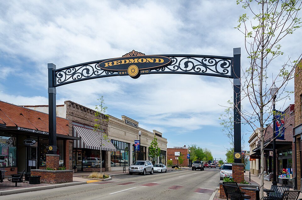 Redmond’s downtown arch above storefronts and a tree-lined street.