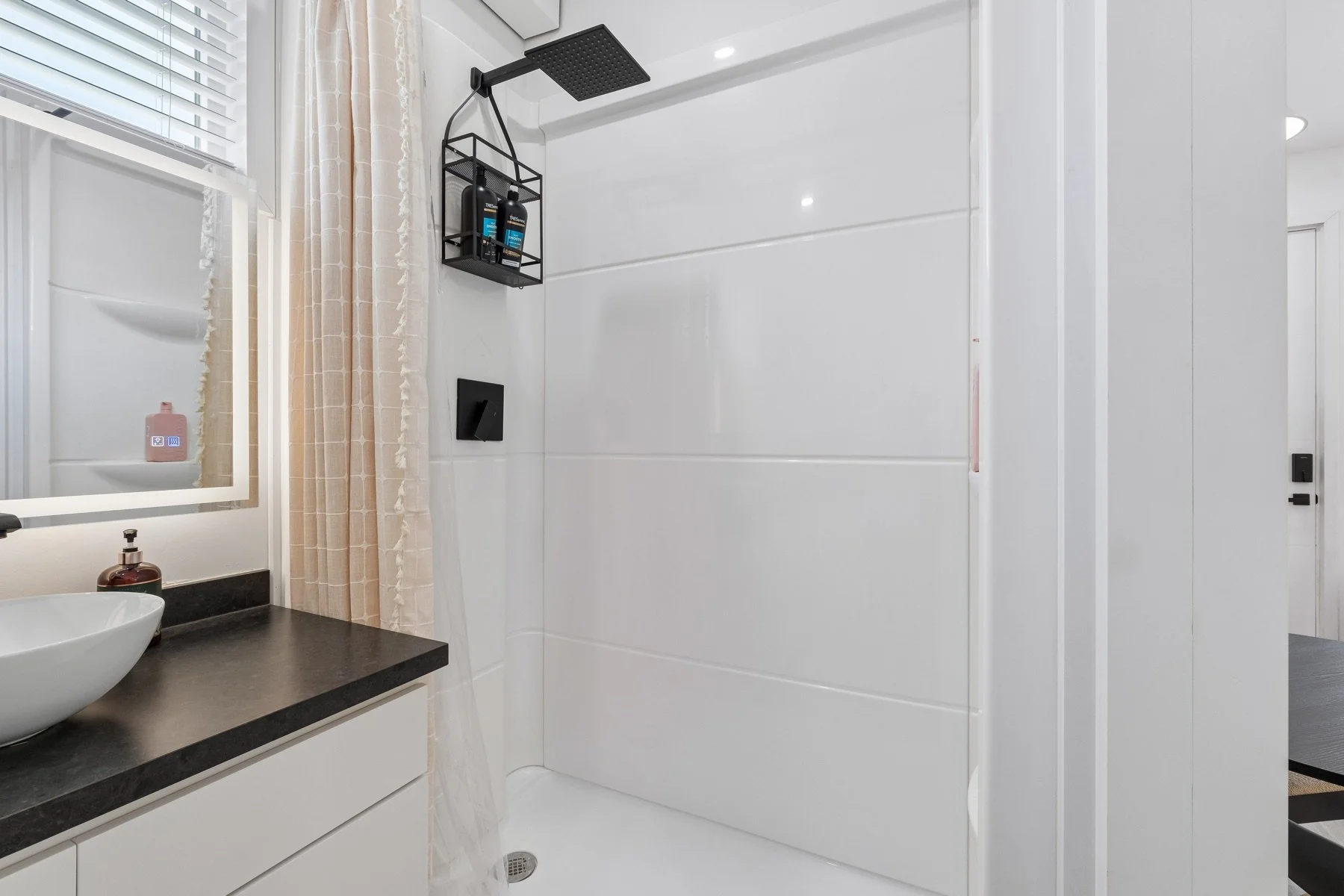 Clean Pasadera bathroom with vanity and shower