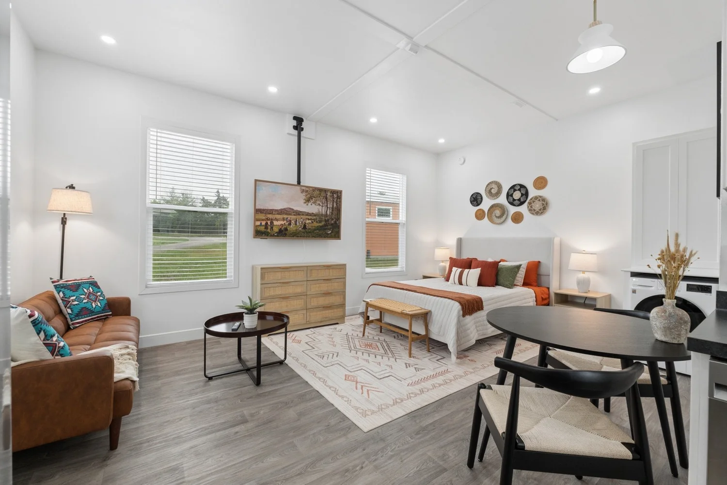 Furnished Pasadera studio living area with sofa, dining table and kitchenette — Nested Tours vacation rental photography, Oklahoma
