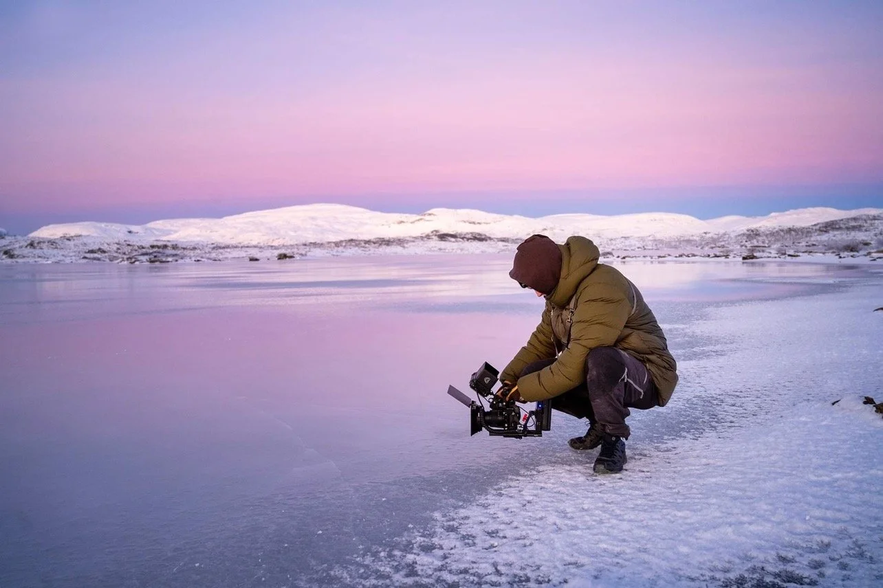 Guests enjoying hot drinks under the Arctic sky