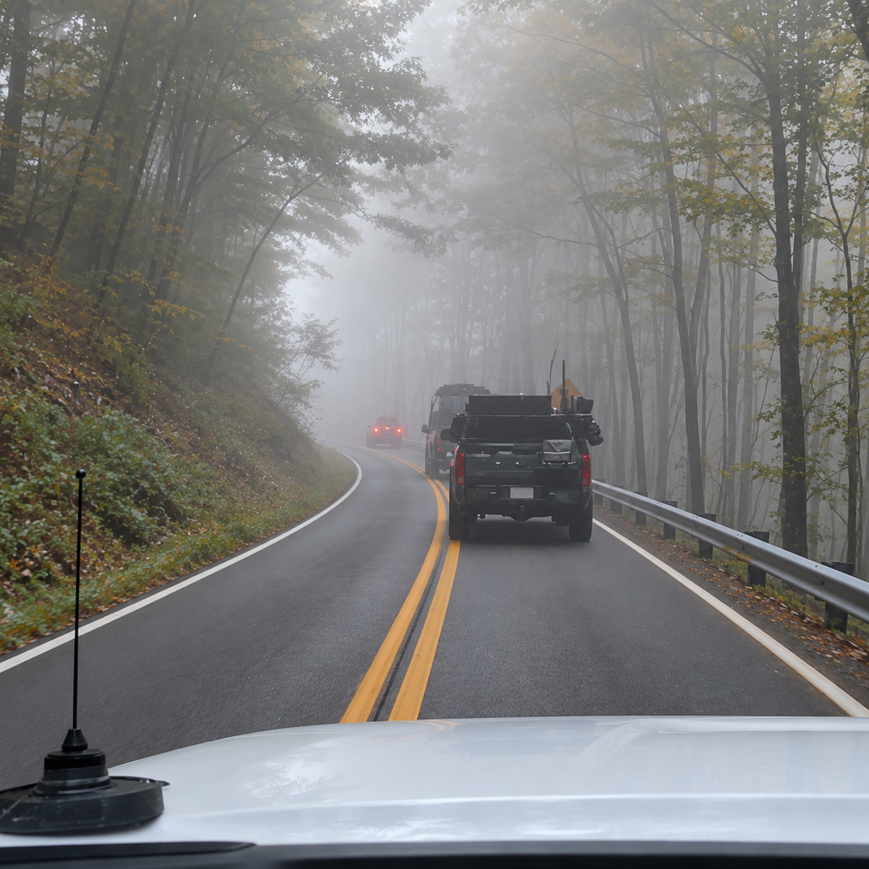 Overland convoy driving a misty autumn forest road on the foggy first morning of Expedition Monongahela, West Virginia
